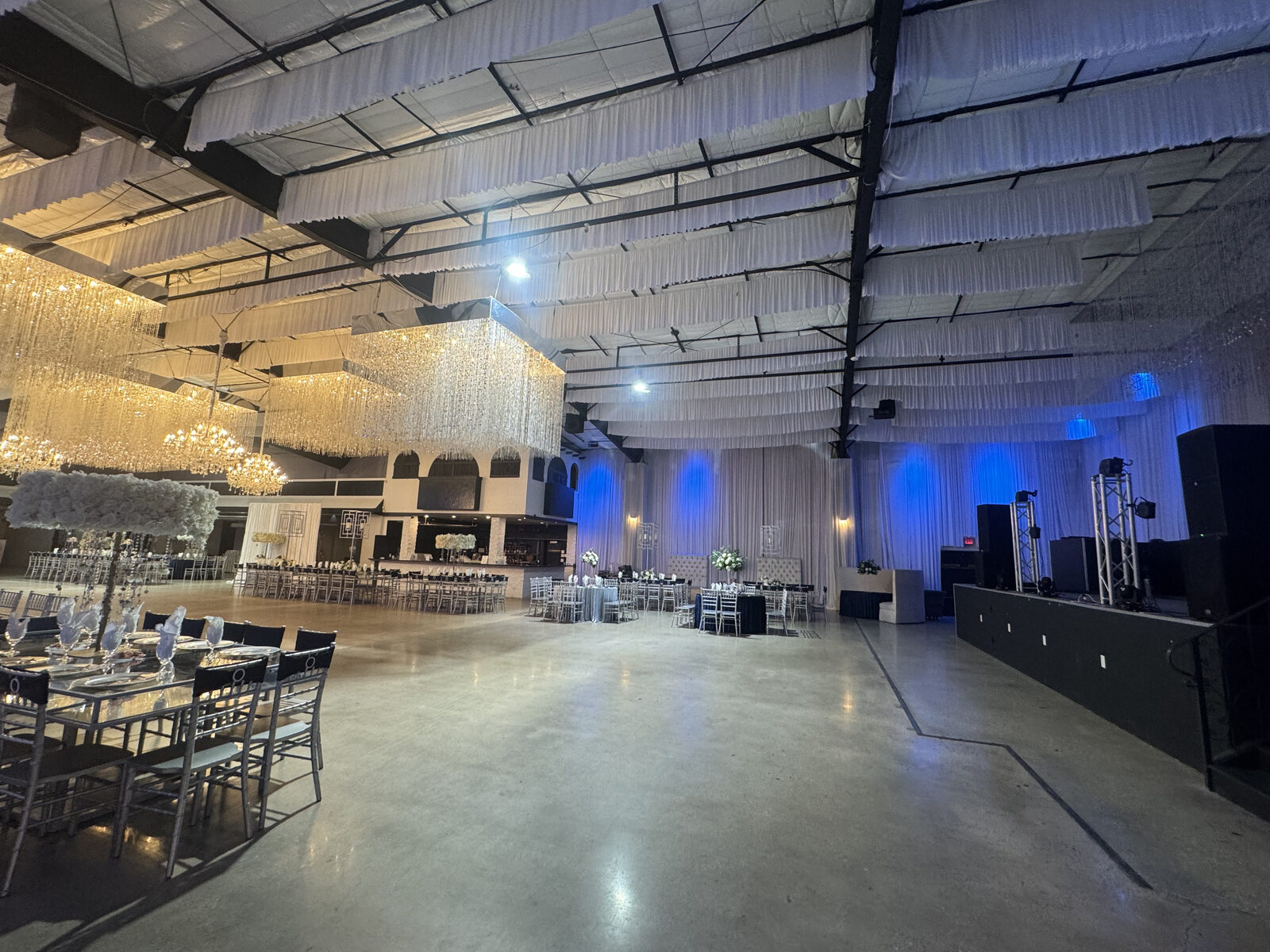 Formal event hall in Houston with chandeliers and draped ceilings