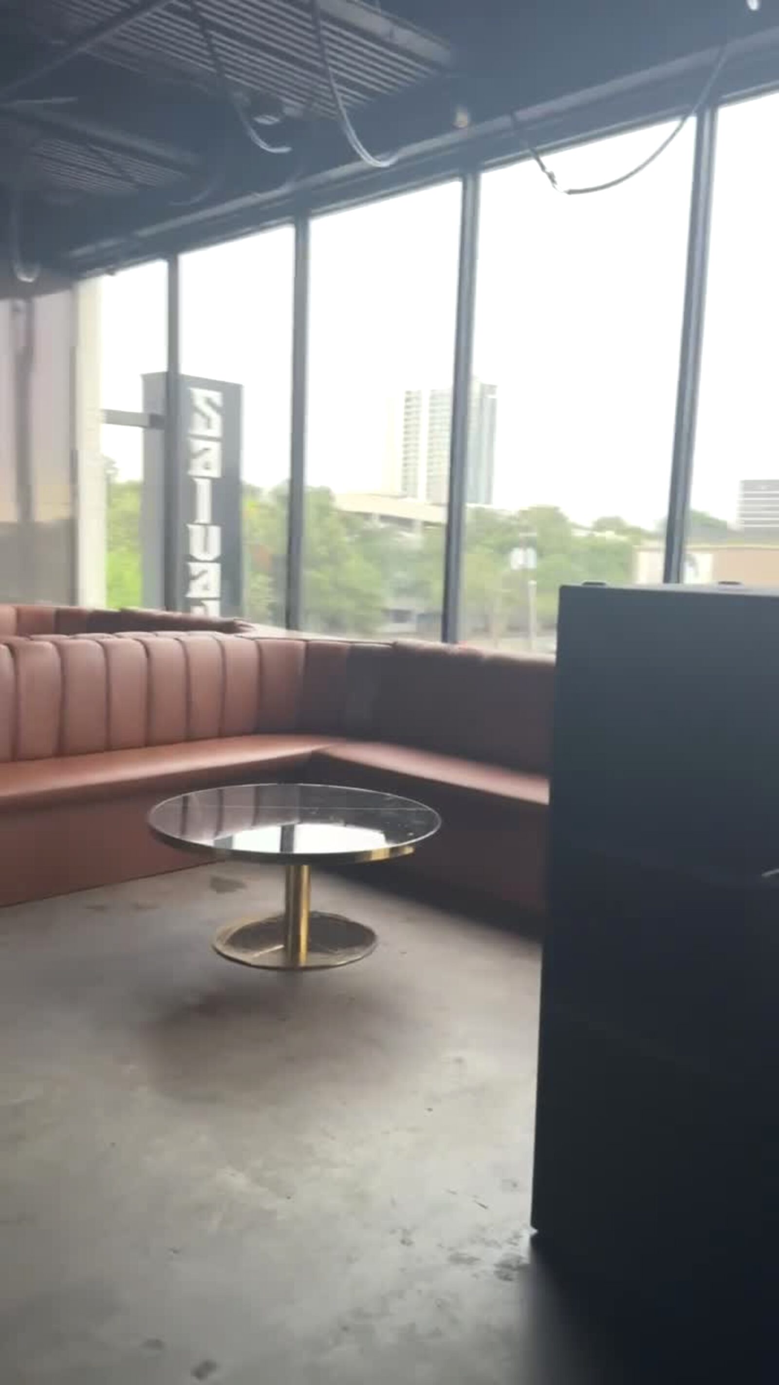 Leather banquettes and skyline windows in a high-end Houston club